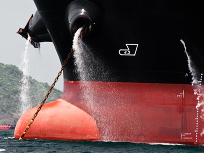 Image of ballast water being discharged from ship's bow