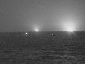 Night shot shows lights on three Iranian vessels approaching U.S. vessel