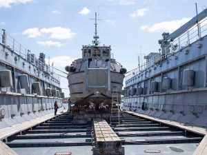 Round bottomed dive boat in Navy's oldest floating dry-dock, the Dynamic (AFDL 6), which routinely docks Landing Craft Utility (LCUs) and other flat-bottom craft.