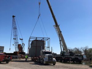 Crane handles large cargo item onto truck at Ports of Indiana