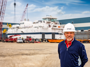 Maxie McGuire of Callan Marine with the General MacArthur dredge behind him