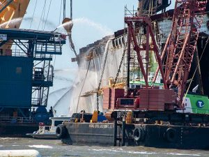 Multiplle vessels spray wateer on Golden Ray wreck following fire
