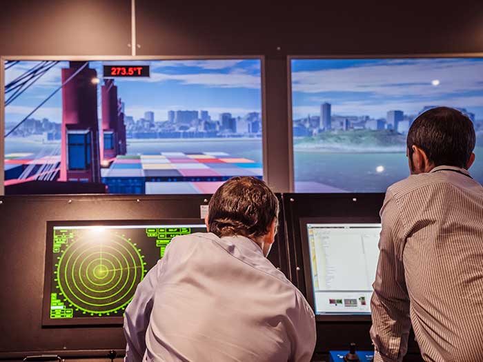 Two men on simulator bridgde