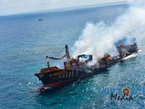 Burned out shell of containership seen from air