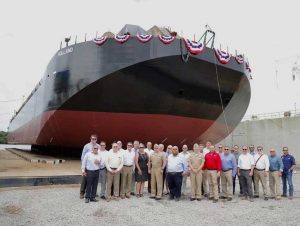 Group in front of ocean transport barge