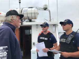 Coast Guard inspectors with mariner