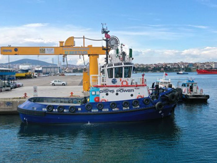 All-electric tugboat alongside in port