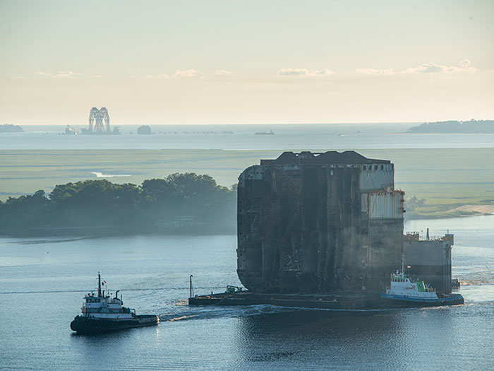 tugs remove section of wreck