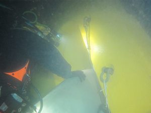 Diver examines damaged propeller