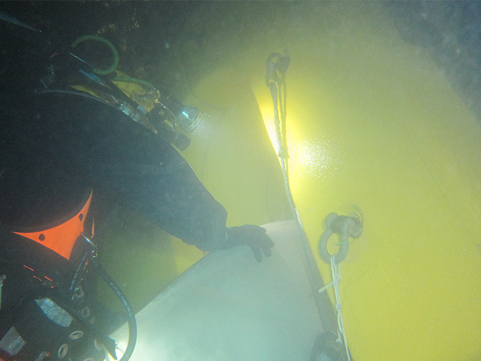 Diver examines damaged propeller