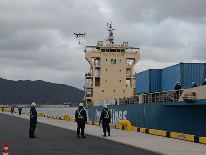 Ship with drone near bridge