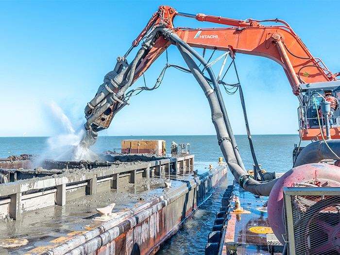 USACE contractor Ryba Marine Construction Co. pumps dredged material from a scow in Toledo Harbor