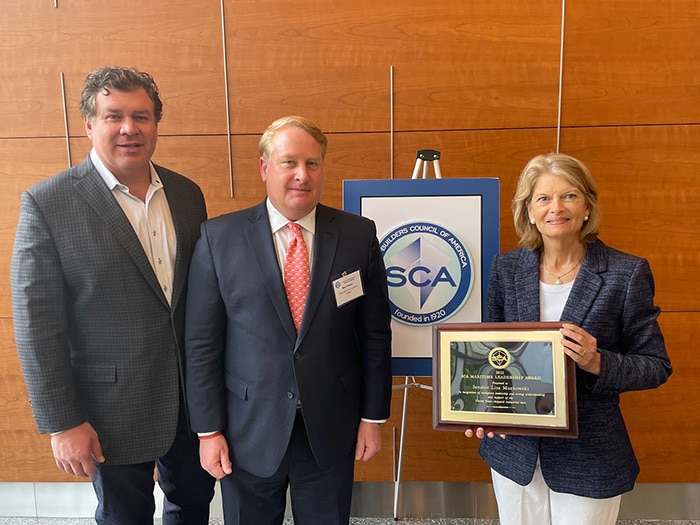 Senator Lisa Murkowski hols SCA award plaque