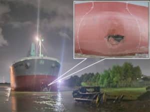 Hole in bulker bow after strike on office barge