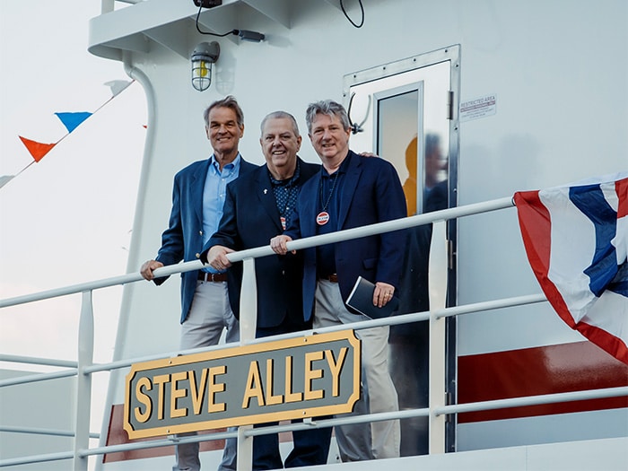 Ingram Marine group people look at boats nameplate