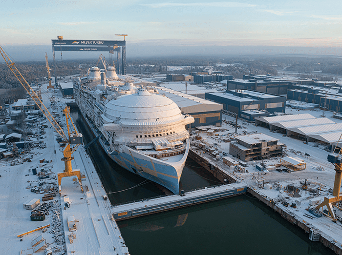 Large cruise ship in dry dock at Finnish shipyard.