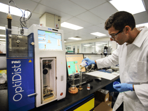 Chemist undergoing marine fuel testing in a lab.