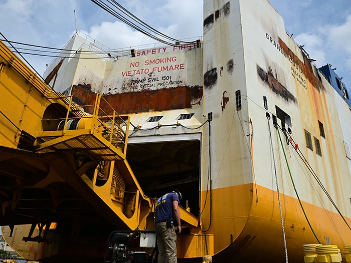 With the ship fire extinguished, the response moves into the salvage and investigation phase.