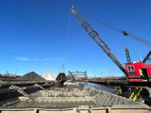 A dredging vessel fills a barge with material pulled from the bottom of the Cuyahoga River, Cleveland, Ohio, November 15, 2023.