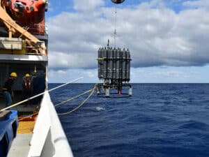 A rosette of sample bottles being recovered from the water during the 2023 A16N GO-SHIP cruise on the NOAA Ship Ronald H. Brown, which traveled from Suape, Brazil, to Reykjavik, Iceland. Devices such as this one will be used to monitor carbon as a part of this BIL funding. (Image credit: Laura Cimoli)