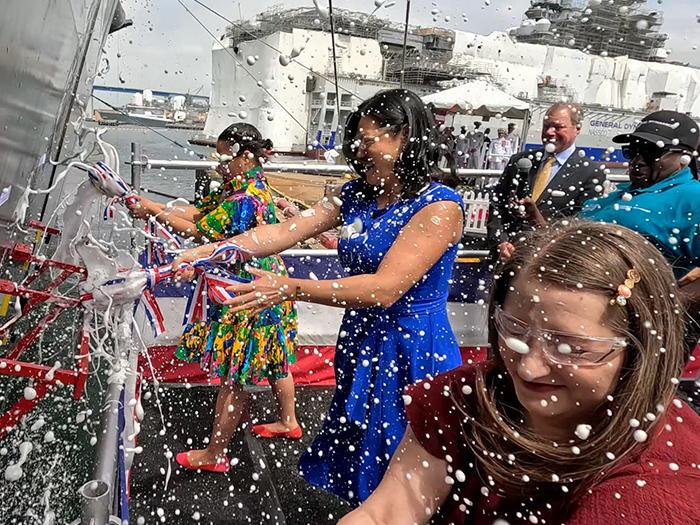 The official christening moment happened when the ship's -sponsors, Melonie Tibbs and Cecilia Marshall, granddaughters of Thurgood Marshall and Dr. Alissa Kamens, Marshall’s granddaughter-in-law, broke a bottle of champagne against the ship’s hull. [Photo: NASSCO]