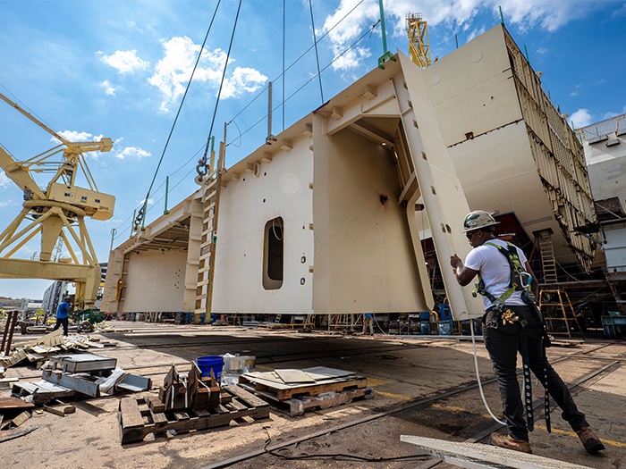 Shipbuilders at HII’s Ingalls Shipbuilding division secure the unit during installation of a grand block for Thad Cochran (DDG 135). The block is one of several units built by Gulf Copper and Eastern Shipbuilding as part of Ingalls’ distributed shipbuilding initiative. [Photo: HII]